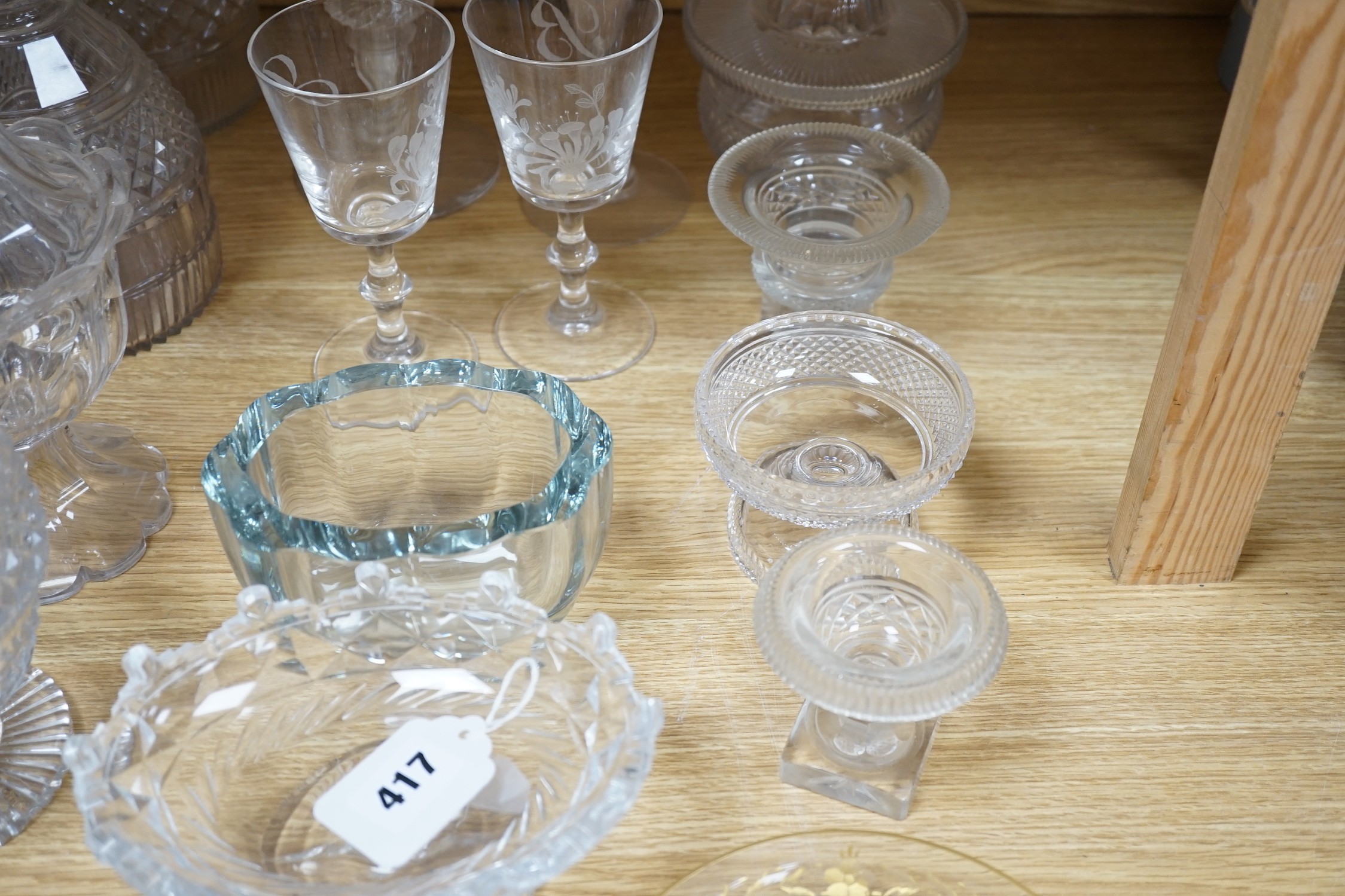 A collection of 19th century hobnail-cut salts, pots, jars and a pair of decanters, etched glasses, etc.